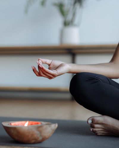 Close-up shot of hands in a meditative yoga mudra.